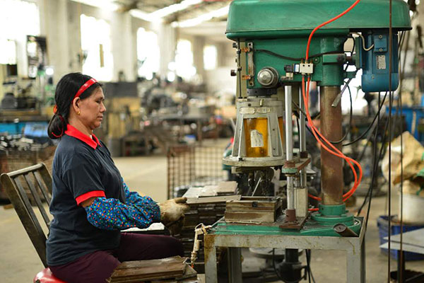 Factory worker at production station, DRS Furnitures